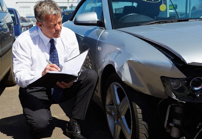 a car insurance claim being filed online with a laptop